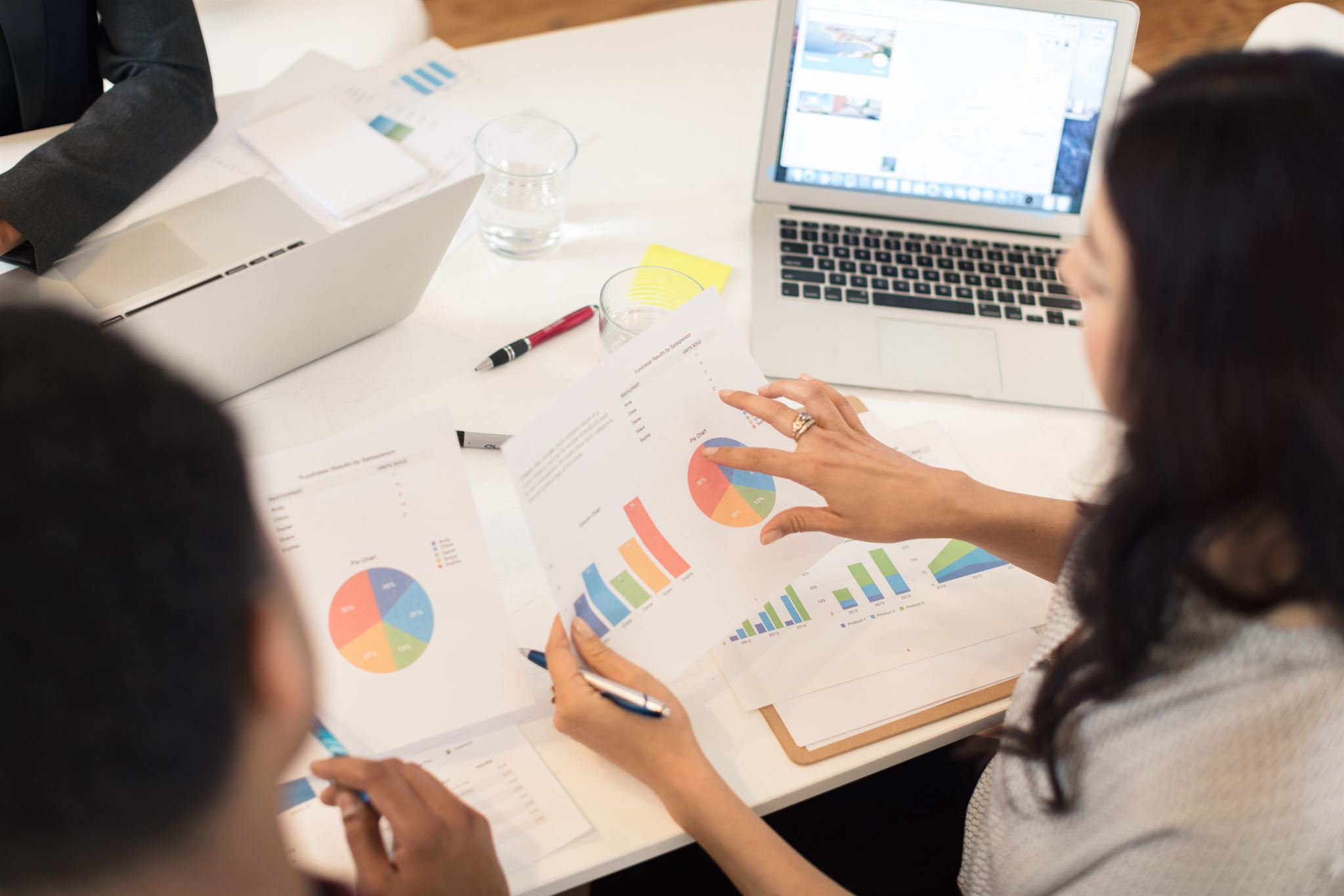 Business meeting discussing registration FAQs